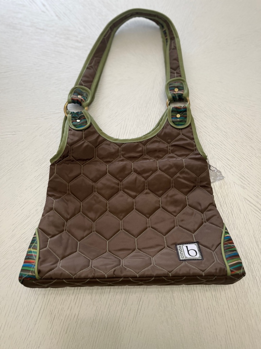 Cinda B quilted shoulder bag quilted honeycomb pattern striped interior lining